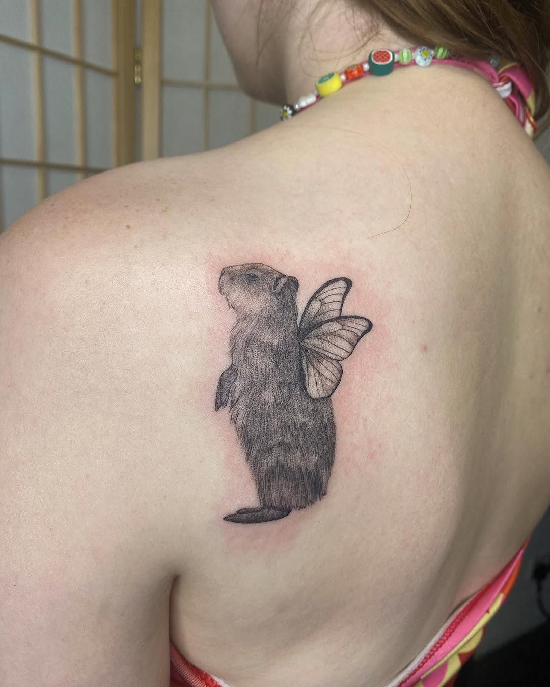 Whimsical capybara tattoo with butterfly wings
