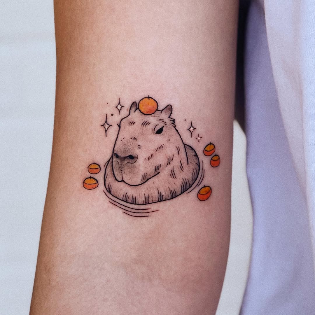 Adorable capybara tattoo with citrus accents