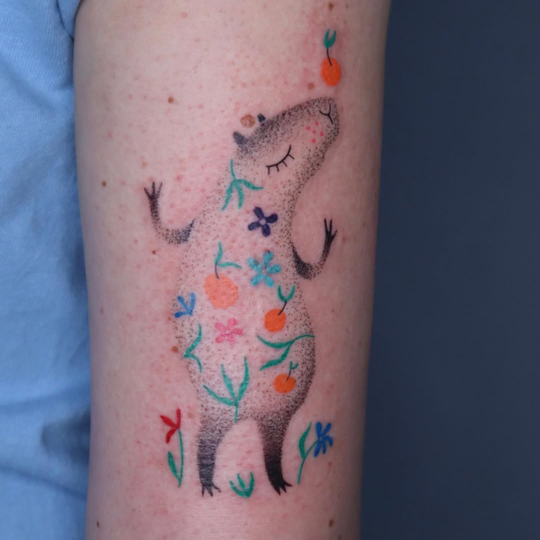 Vibrant Capybara Tattoo Surrounded by Nature