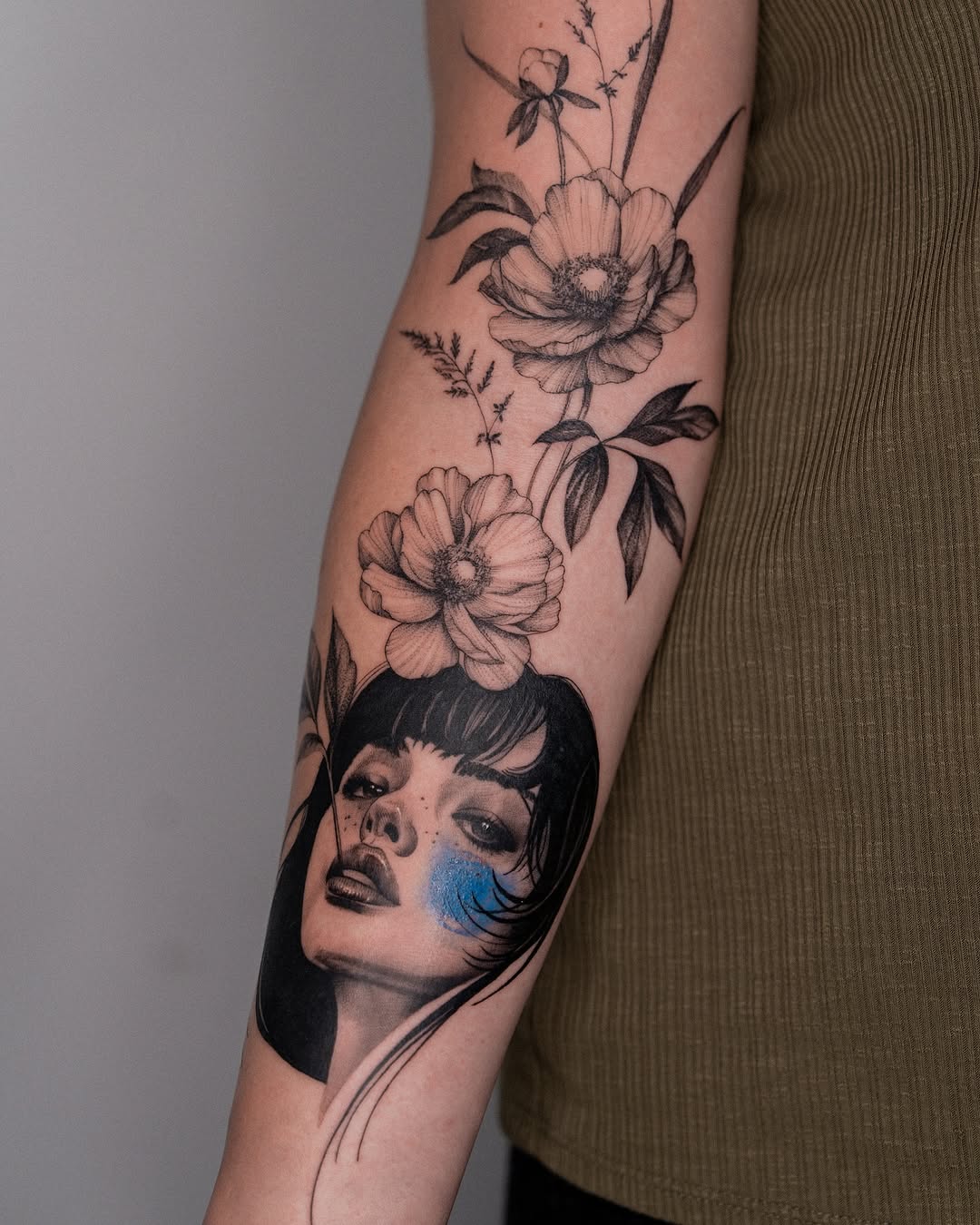 Intricate floral portrait tattoo exuding strength