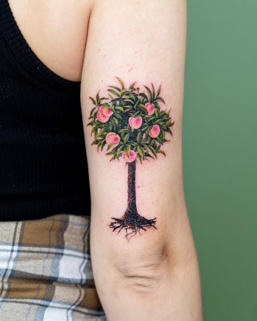 Vibrant tree tattoo with blooming pink flowers