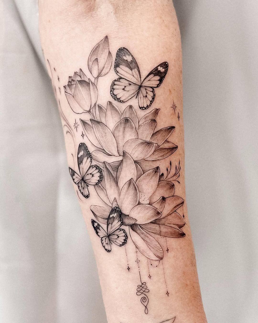 Intricate floral tattoo with delicate butterflies