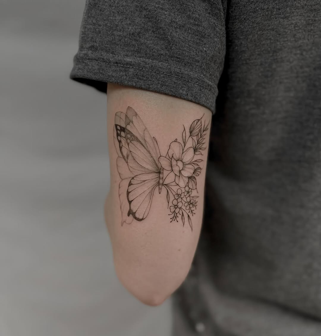 Aesthetic butterfly tattoo with floral elements