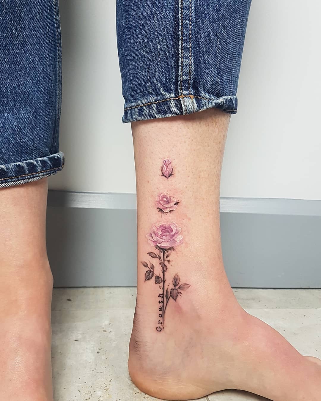 Elegant floral growth tattoo on the ankle