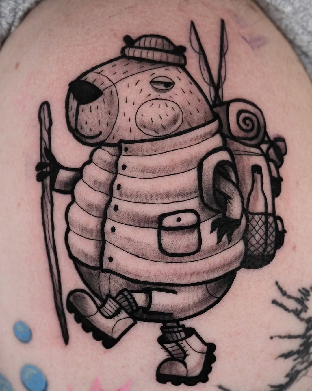 Quirky capybara hiking tattoo design