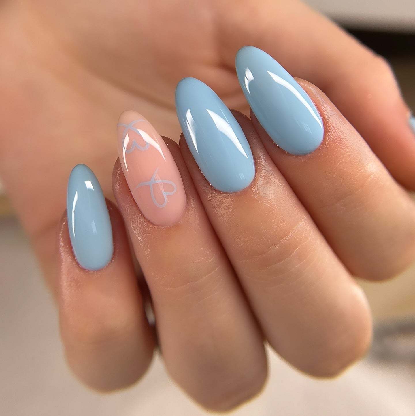 9. Light Blue Almond Nails with Subtle Heart Detail (Light Blue Nail Ideas)
