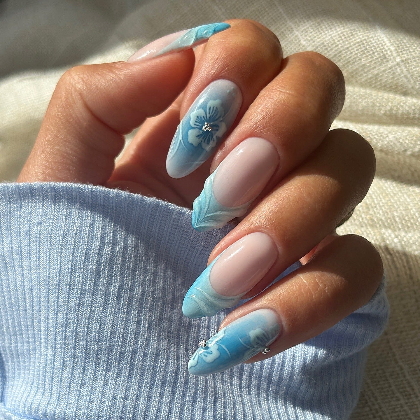 15. Blue Floral Accent Almond Nails (Light Blue Nail Ideas)