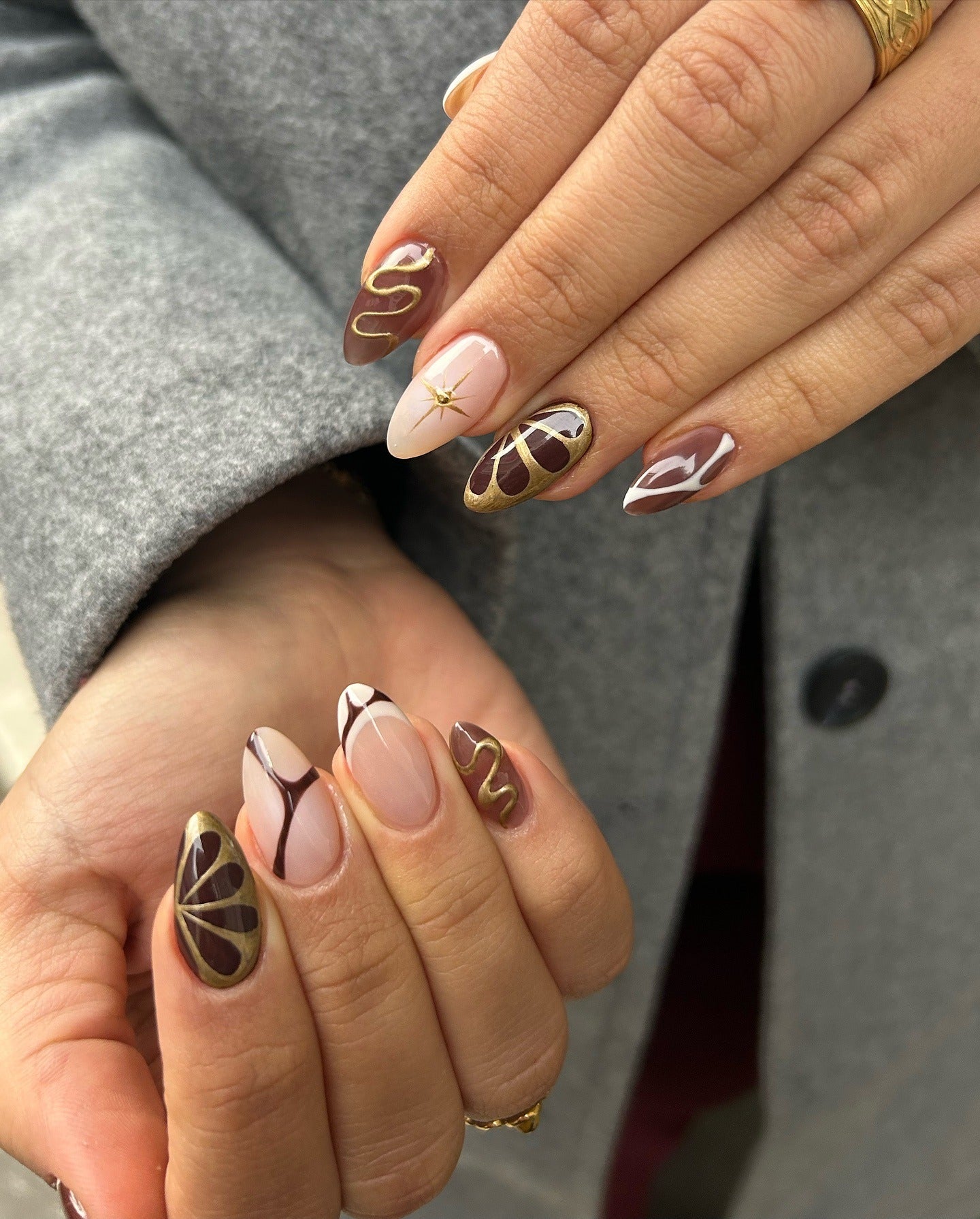 2. Golden Swirl Art on Mocha Base (Brown Nail Ideas)